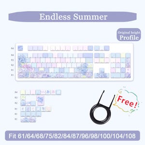 May include: A white keyboard with keycaps featuring a floral design in shades of blue, purple, and pink. The text "Endless Summer" is above the keyboard. Includes a keycap puller and text that says "Free!"