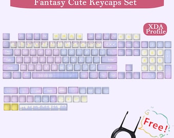May include: A set of pastel-colored keycaps with the text "Fantasy Cute Keycaps Set." The keycaps are in shades of purple, blue, and yellow. Includes a keycap puller and a "Free!" sticker. The keycaps are designed with an XDA profile.
