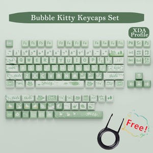 May include: A set of Bubble Kitty keycaps in a light green and white color scheme. The keycaps feature a marble-like pattern and decorative icons. The set includes a keycap puller and the text "Free!"
