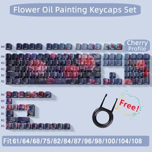 May include: A set of flower oil painting keycaps for a mechanical keyboard. The keycaps feature a floral design with pink, purple, and white flowers. The keycaps are compatible with 61, 64, 68, 75, 82, 84, 87, 96, 98, 100, 104, and 108 key keyboards. The keycaps are labeled with the Cherry profile. The image also includes a free keycap puller.