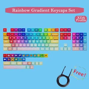 May include: A rainbow gradient keycaps set with XDA profile. The set includes keycaps in various colors, including red, orange, yellow, green, blue, and purple. The image also shows a keycap puller tool. The text "Rainbow Gradient Keycaps Set" is displayed.