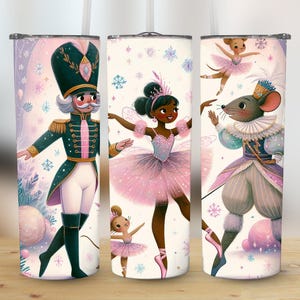 May include: Three insulated tumblers with illustrations of characters from The Nutcracker ballet. The designs feature a nutcracker soldier in a green uniform, a ballerina in a pink tutu, and a mouse king. The background has snowflakes and a soft pink and purple color scheme.
