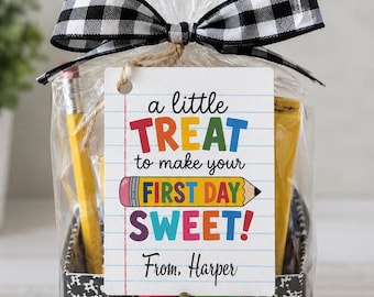 May include: A clear plastic gift bag containing yellow pencils and a black and white composition notebook pattern box. A black and white buffalo check ribbon ties the top. A white tag reads: a little TREAT to make your FIRST DAY SWEET! From, Harper.