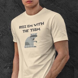 Rizz &#39;Em With The &#39;Tism T Shirt for Teens and Gen Z. Funny Raccoon T Shirt. Ironic Raccoon Shirt.