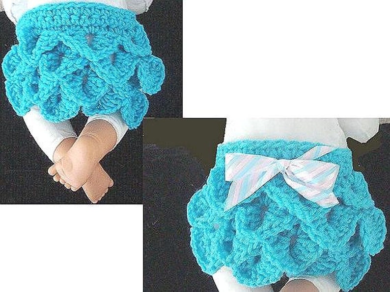 May include: A turquoise crochet skirt with a scalloped design. The skirt has a white and light blue striped bow. The skirt is shown on a baby doll. The skirt is a baby clothing item.