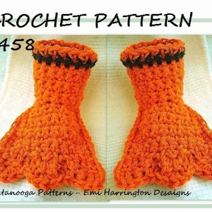 May include: Crochet pattern #458 for a pair of orange and black crocheted hand warmers with a three-toed design. The pattern is from Hectanooga Patterns - Emi Harrington Designs.
