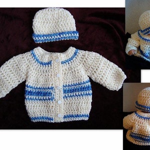 May include: A cream-colored, crocheted baby sweater and matching hat set. The sweater has long sleeves, a button-up front, and blue trim along the collar, cuffs, and pockets. The hat has a blue band. The set is handmade.