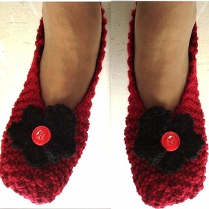 May include: A pair of red knitted slippers with black flower embellishments and red buttons.