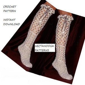 May include: A pair of white crocheted leg warmers with a lace trim and a bow at the top. The leg warmers are on a red background. CROCHET PATTERN INSTANT DOWNLOAD HECTANOOGA PATTERNS