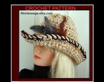 May include: A crocheted hat with a wide brim, featuring a brown and black braided trim and decorative feathers. The hat is beige and has a textured surface.