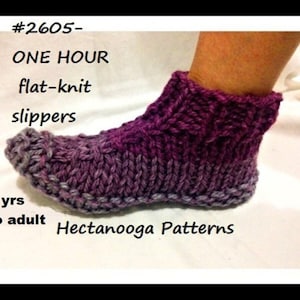 May include: A knitted slipper in shades of purple and gray is shown on a foot. The slipper is made with a flat-knit design. Text on the image reads "#2605- ONE HOUR flat-knit slippers 2 yrs to adult Hectanooga Patterns."