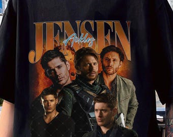 May include: Black t-shirt with a vintage-style graphic of Jensen Ackles. The graphic features a collage of images of Ackles in different roles, including his role as Dean Winchester in the TV show Supernatural.