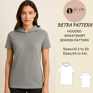 Könnte beinhalten: Eine Frau trägt ein graues Kapuzensweatshirt mit kurzen Ärmeln. Das Bild enthält den Text "BETRA PATTERN HOODED SWEATSHIRT SEWING PATTERN" und Größenangaben. Zwei Strichzeichnungen des Sweatshirts sind ebenfalls abgebildet.