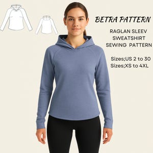 May include: A woman wearing a blue raglan sleeve sweatshirt. The image includes a sewing pattern with the text "BETRA PATTERN" and "RAGLAN SLEEV SWEATSHIRT SEWING PATTERN". Sizes available are US 2 to 30 and XS to 4XL.