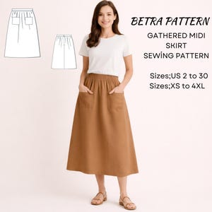 May include: A woman wearing a brown gathered midi skirt with pockets, paired with a white t-shirt and sandals. The image includes a sewing pattern illustration and text that reads "BETRA PATTERN GATHERED MIDI SKIRT SEWING PATTERN" with size details.