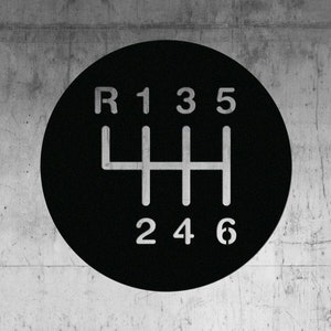 May include: Black and white gear shift pattern with the numbers 1, 2, 3, 4, 5, and 6, and the letter R.