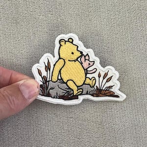 Storybook Pooh & Piglet Patch | 2.25x3 Inch Embroidered Iron-On | Classic Disney Rock Sitting