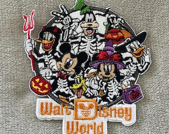 May include: Embroidered patch featuring Disney characters in skeleton costumes, including Mickey Mouse, Donald Duck, and Goofy, celebrating Halloween. The patch has the text "Walt Disney World" in orange and white.