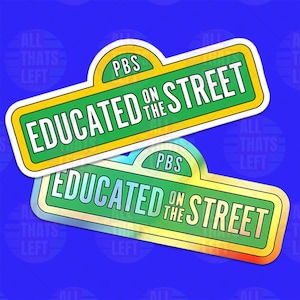 May include: Two stickers with a green and yellow design, featuring the text "EDUCATED ON THE STREET" and "PBS" in white. The stickers are on a blue background. The stickers are rectangular with rounded corners.