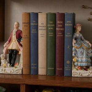 May include: A set of six vintage hardcover books titled Howards End, The Virginian, The Finished Portrait, The Golden Bowl, Pride and Prejudice, and Anna Karenina, flanked by two porcelain bookends depicting a person in period attire.