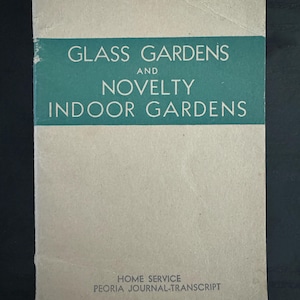 May include: A vintage book cover with the title "Glass Gardens and Novelty Indoor Gardens". The cover is beige with a green band at the top and bottom. The text is in black.