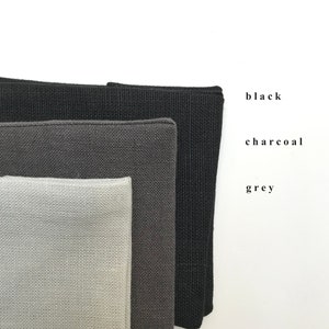 May include: Three fabric swatches in different shades of gray: black, charcoal, and gray.
