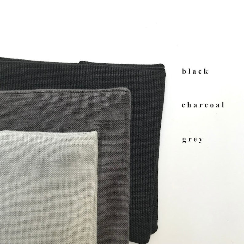 May include: Three fabric swatches in different shades of gray: black, charcoal, and gray.