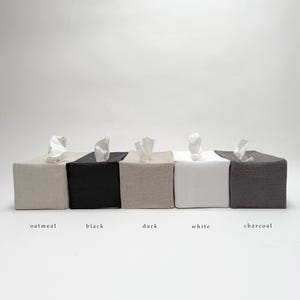 May include: Five tissue box covers in different colors: oatmeal, black, dark beige, white, and charcoal.