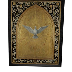 May include: A rectangular wall plaque featuring a central white dove with wings spread wide against a gold background. The dove is surrounded by radiating light rays and small flame motifs. The piece is enclosed in a black frame with ornate floral carvings.