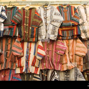 May include: A row of colourful striped jackets with a variety of patterns and colours, including red, blue, green, yellow and white.