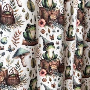 A close-up of draped fabric shows a repeating pattern of green frogs in wizard hats on tree stumps, surrounded by mushrooms and leaves.