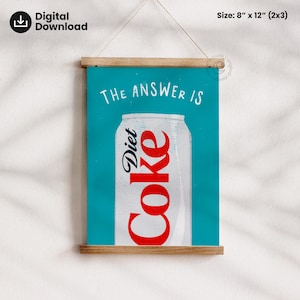 May include: A digital print of a Diet Coke can with the words "THE ANSWER IS". The can is white with red lettering. The print measures 20 cm x 30 cm and is mounted on a wooden frame, perfect for a kitchen or dining area.
