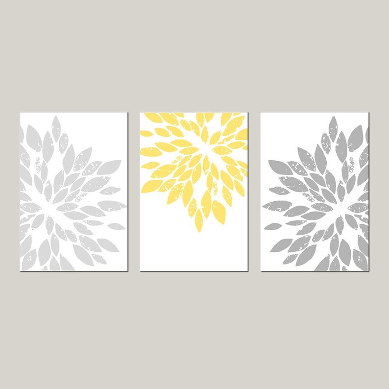 May include: Three abstract art prints with a white background and a gray and yellow floral design. The prints are arranged in a row.