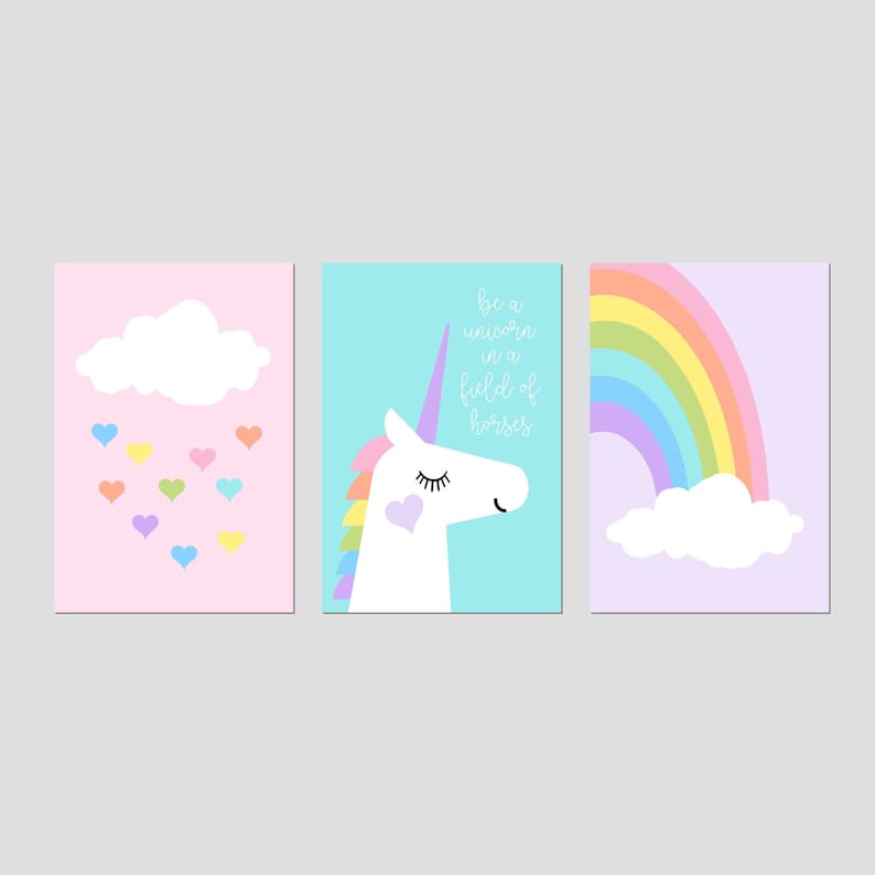 May include: Three framed art prints with a unicorn, rainbow, and cloud theme. The unicorn print has the text "be a unicorn in a field of horses". The rainbow print has a rainbow and cloud. The cloud print has hearts.