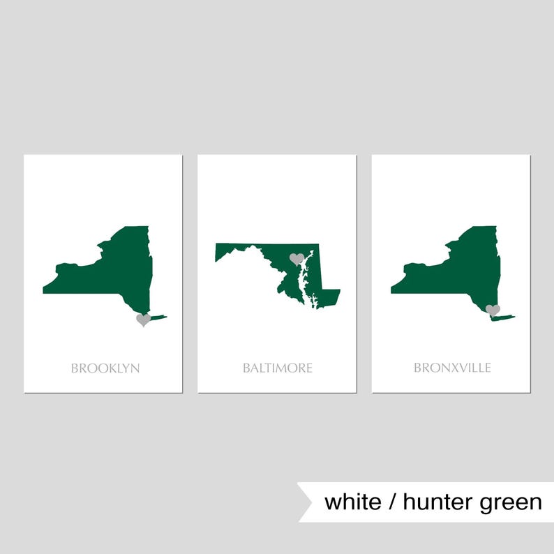 May include: Three white prints with green outlines of the states of New York, Maryland, and New York. Each print has a small gray heart marking a city: Brooklyn, Baltimore, and Bronxville.