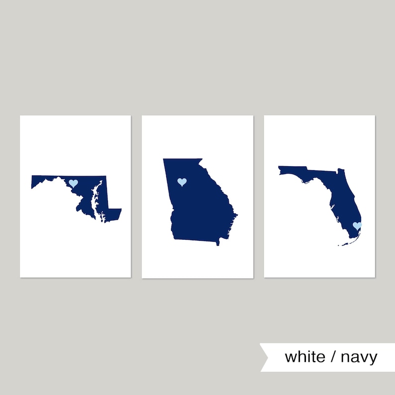 May include: Three white prints with navy blue outlines of the states of Maryland, Georgia, and Florida. Each state has a small light blue heart in the center.