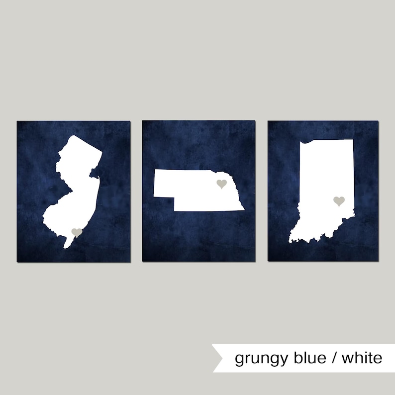 May include: Three white state outlines on a blue background. The states are New Jersey, Nebraska, and Indiana. Each state has a small gray heart in the center.