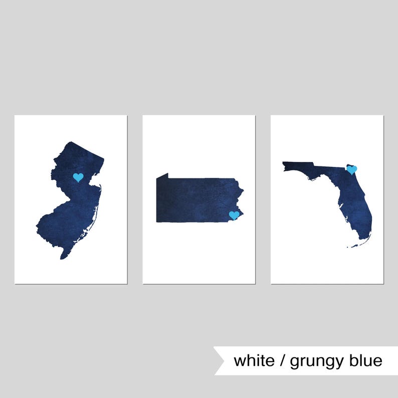 May include: Three printable wall art prints featuring the outlines of New Jersey, Pennsylvania, and Florida. Each state is filled with a dark blue watercolor-like design and has a small blue heart in the center.