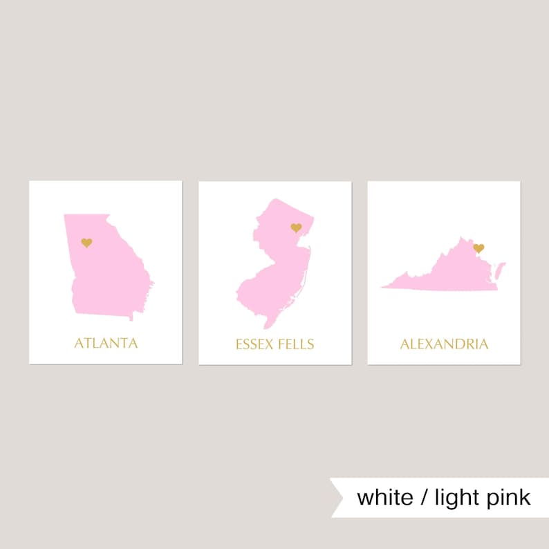 May include: Three printable maps with pink outlines of Georgia, New Jersey, and Virginia. Each map has a gold heart marking a specific location. The text below each map reads "Atlanta", "Essex Fells", and "Alexandria". The text "white / light pink" appears below the maps.