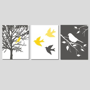 May include: A set of three wall art prints featuring a black and white silhouette of a tree with a yellow bird, three yellow birds flying, and a white bird on a branch. The prints are on a white background.