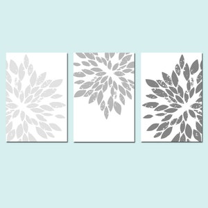 May include: Set of three printable wall art prints featuring a gray and white floral design. The prints have a distressed, vintage look.