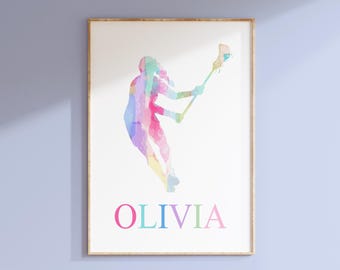 May include: A watercolor illustration of a lacrosse player in a variety of pastel colors. The player is in mid-air, holding a lacrosse stick. The name "OLIVIA" is printed below the player in pink, teal, and green.
