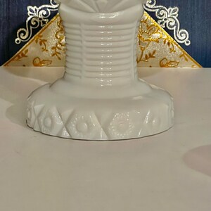 May include: White milk glass pedestal with a fluted design and a scalloped base with a floral pattern.