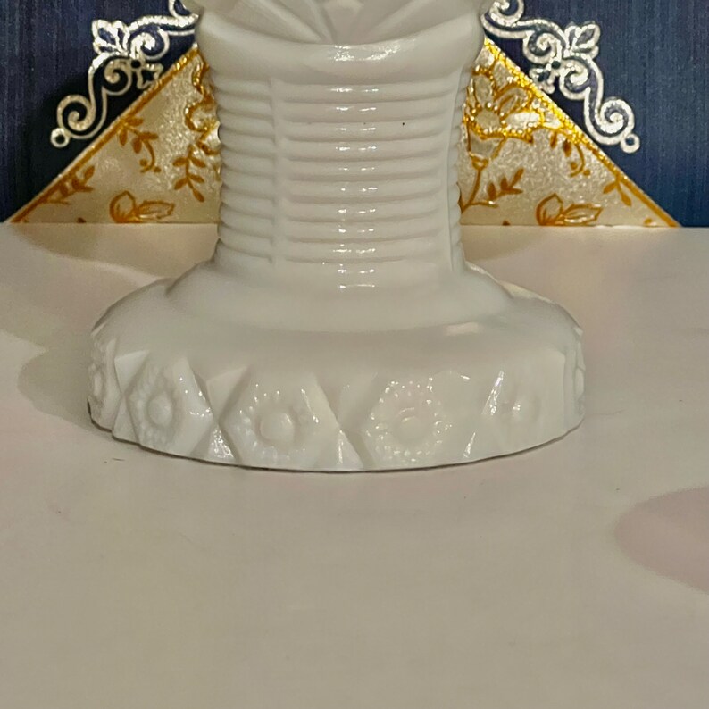 May include: White milk glass pedestal with a fluted design and a scalloped base with a floral pattern.