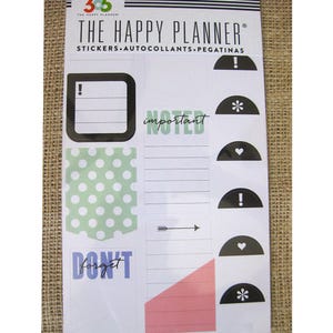 May include: A sheet of stickers for a planner with a green polka dot design, a pink triangle, a black and white arrow, a black rectangle with a white exclamation point, a white rectangle with the text "important noted", and several black half-circle stickers with different symbols.
