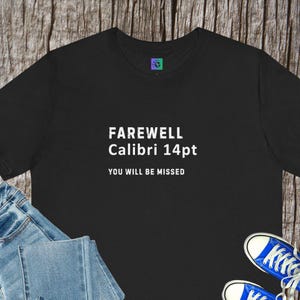May include: Black t-shirt with the text "FAREWELL Calibri 14pt YOU WILL BE MISSED" in white. The shirt is paired with blue jeans and blue sneakers. A small logo is visible on the upper left of the shirt.