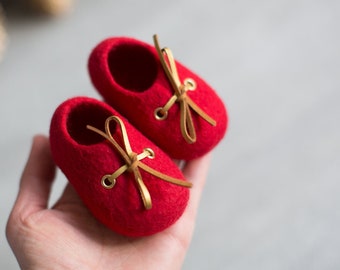 Red wool shoes for newborn baby with golden laces packed in a box, Christmas pregnancy reveal to grandparents, Baby announcement gift idea