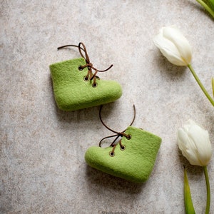 Fresh green baby shoes with brown shoe laces