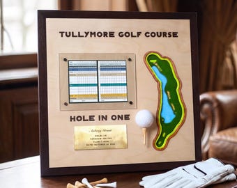 May include: A square wooden display plaque titled Tullymore Golf Course Hole In One, featuring a scorecard, a topographical map of a golf hole, a golf ball on a tee, and a brass plate engraved with Aubrey Grant, hole 18, 498 yards, 7 iron, October 24, 2024.