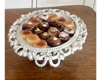 Selection of the finest miniature Belgian chocolates on a beautiful white plate